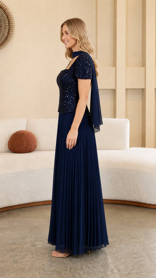 Model wearing Navy Blue formal pleated maxi gown side profile view