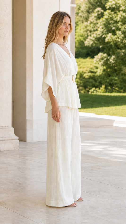 Side view of model in ivory kimono sleeve belted top and matching palazzo pants