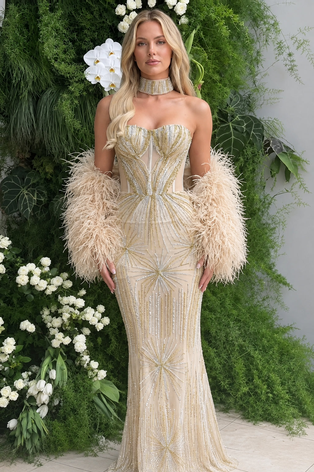Champagne gold strapless beaded mermaid evening dress with feather accents