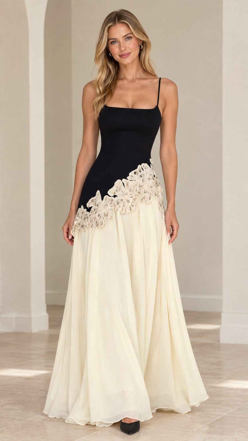 Front full view of black and cream spaghetti strap evening gown with asymmetric lace waist detail