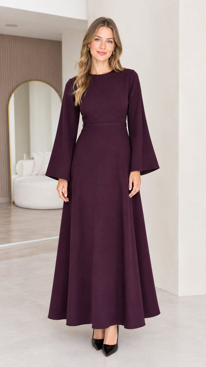 Front view of a burgundy women's long sleeve A-line maxi dress with a defined waist