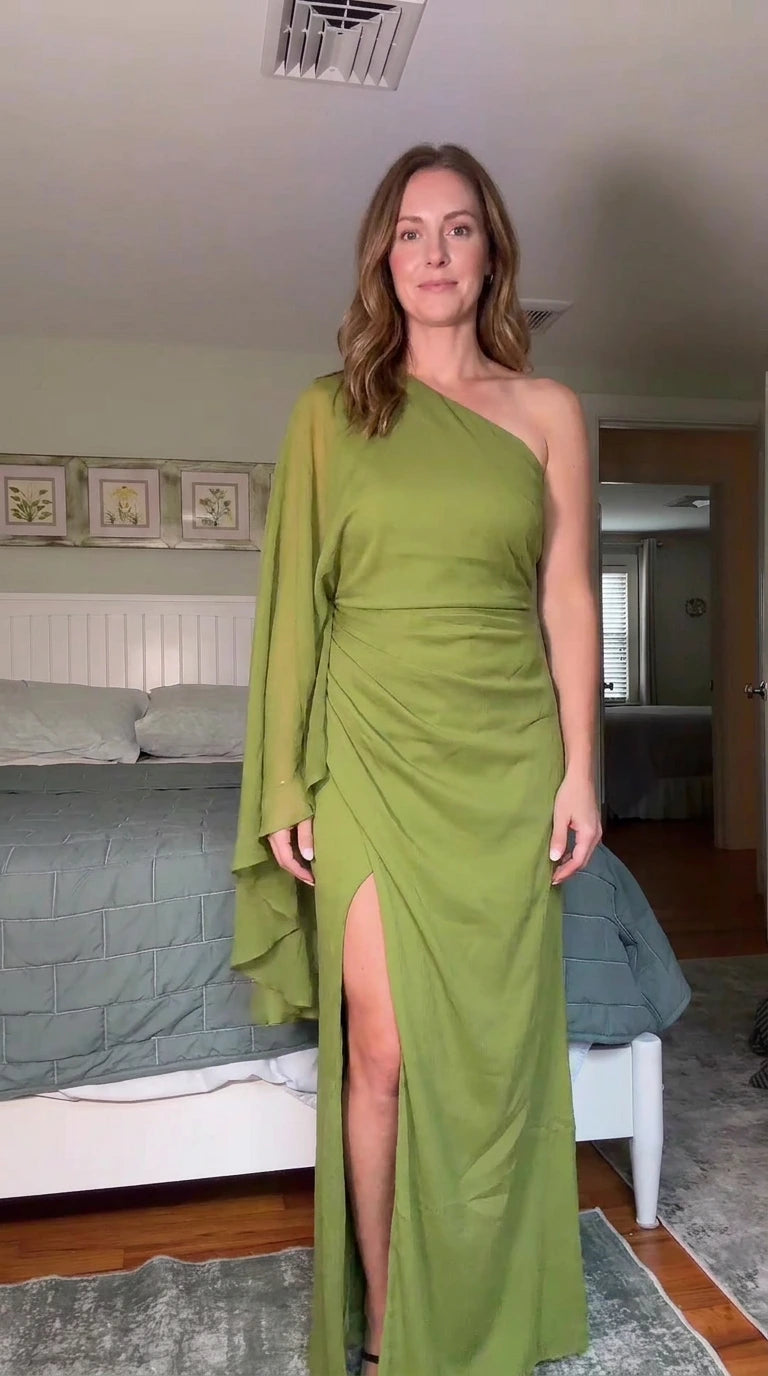 Front view of olive green one-shoulder cape sleeve maxi dress with side slit