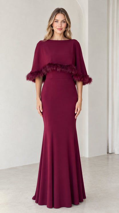 Front view of burgundy mermaid evening dress with feather trim capelet