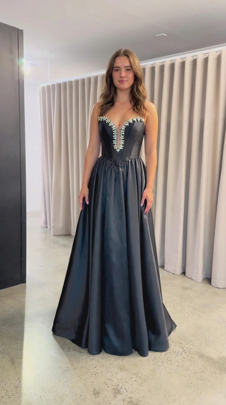 Front view of black strapless satin evening gown with crystal sweetheart neckline