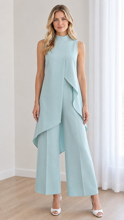 Front view of model wearing a powder blue sleeveless mock neck jumpsuit with asymmetrical overlay