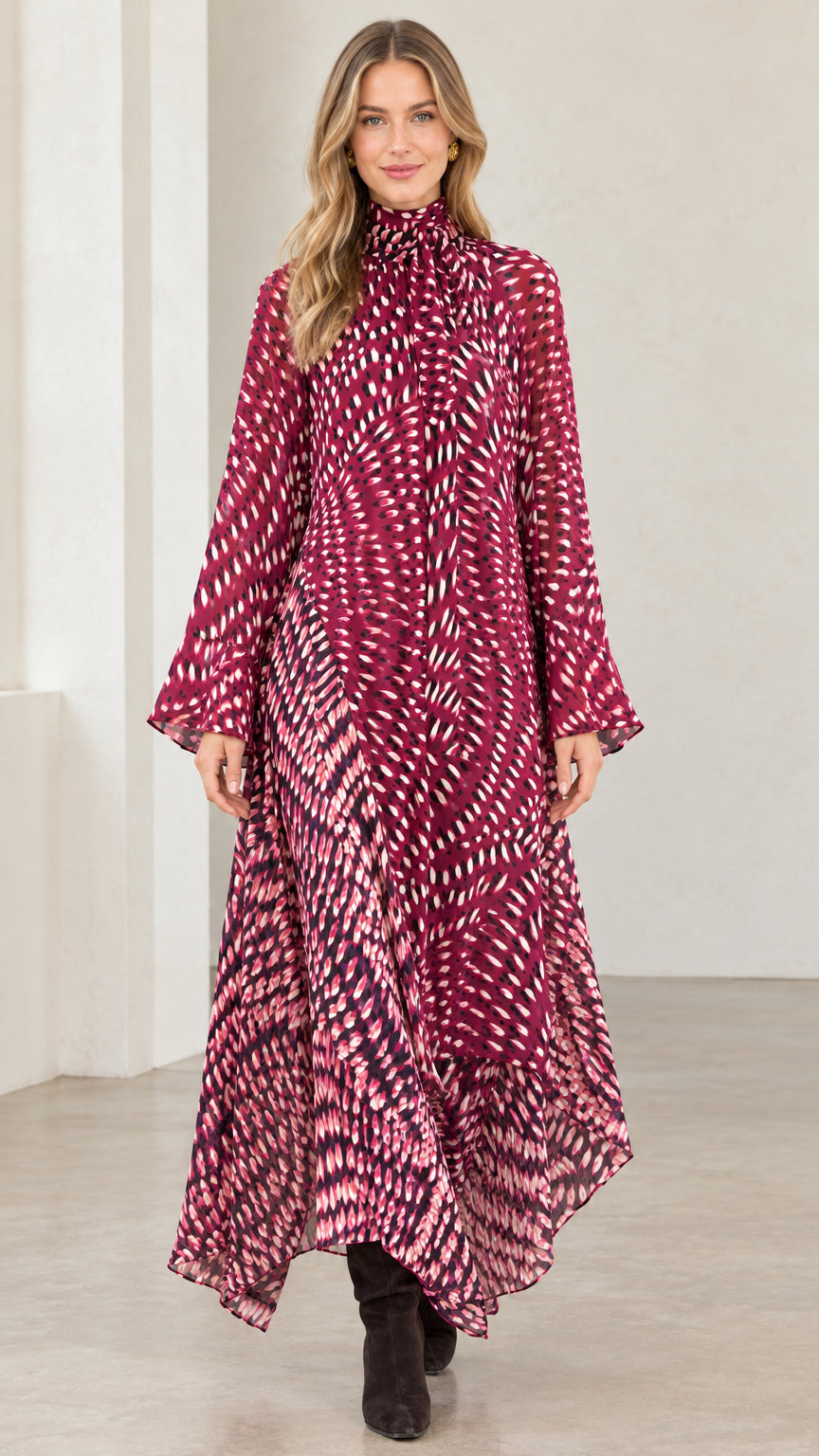 Front view of model wearing magenta abstract print high neck asymmetrical maxi dress