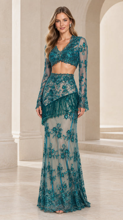 Front view of model wearing Teal two-piece sequin lace evening gown with long sleeves and beaded fringe skirt