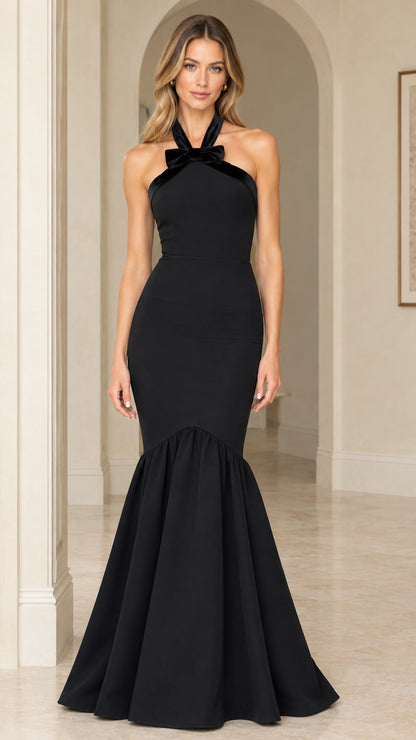 Front view of black halter mermaid evening gown with bow detail