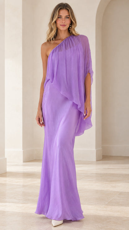Front view of model wearing a lavender one-shoulder draped cape maxi dress