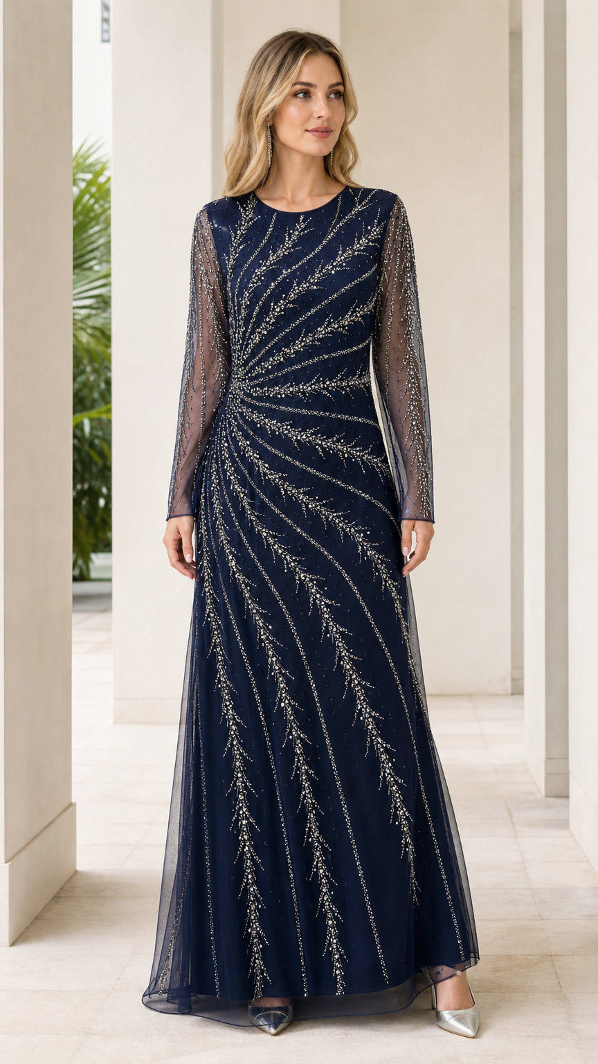 Front view of woman wearing navy blue long sleeve beaded formal maxi gown