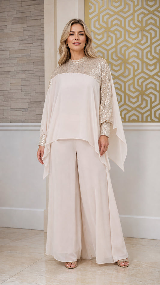 Front view of champagne sequin capelet two-piece evening pant set on model