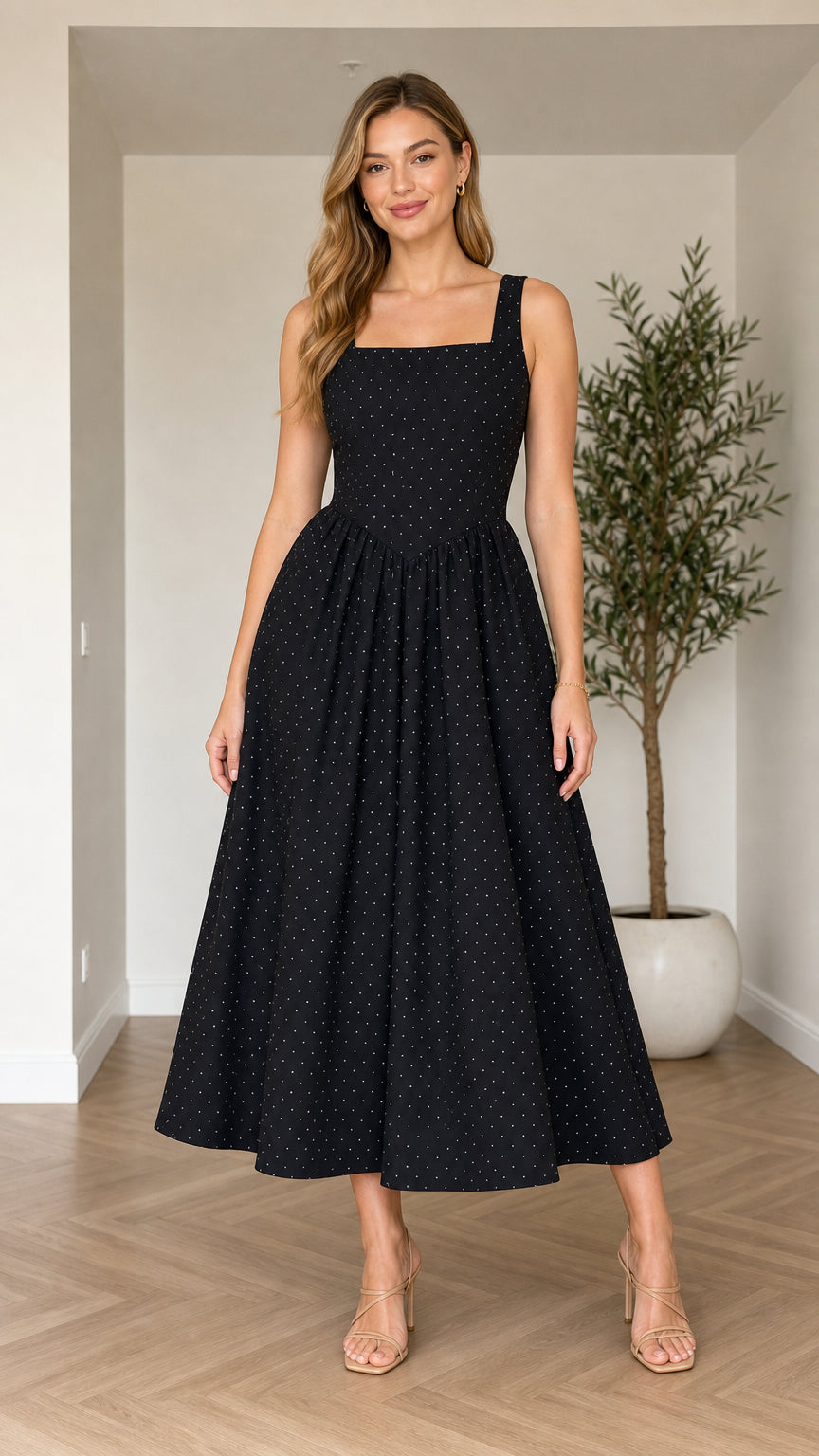 Front view of model wearing black polka dot square neck midi dress