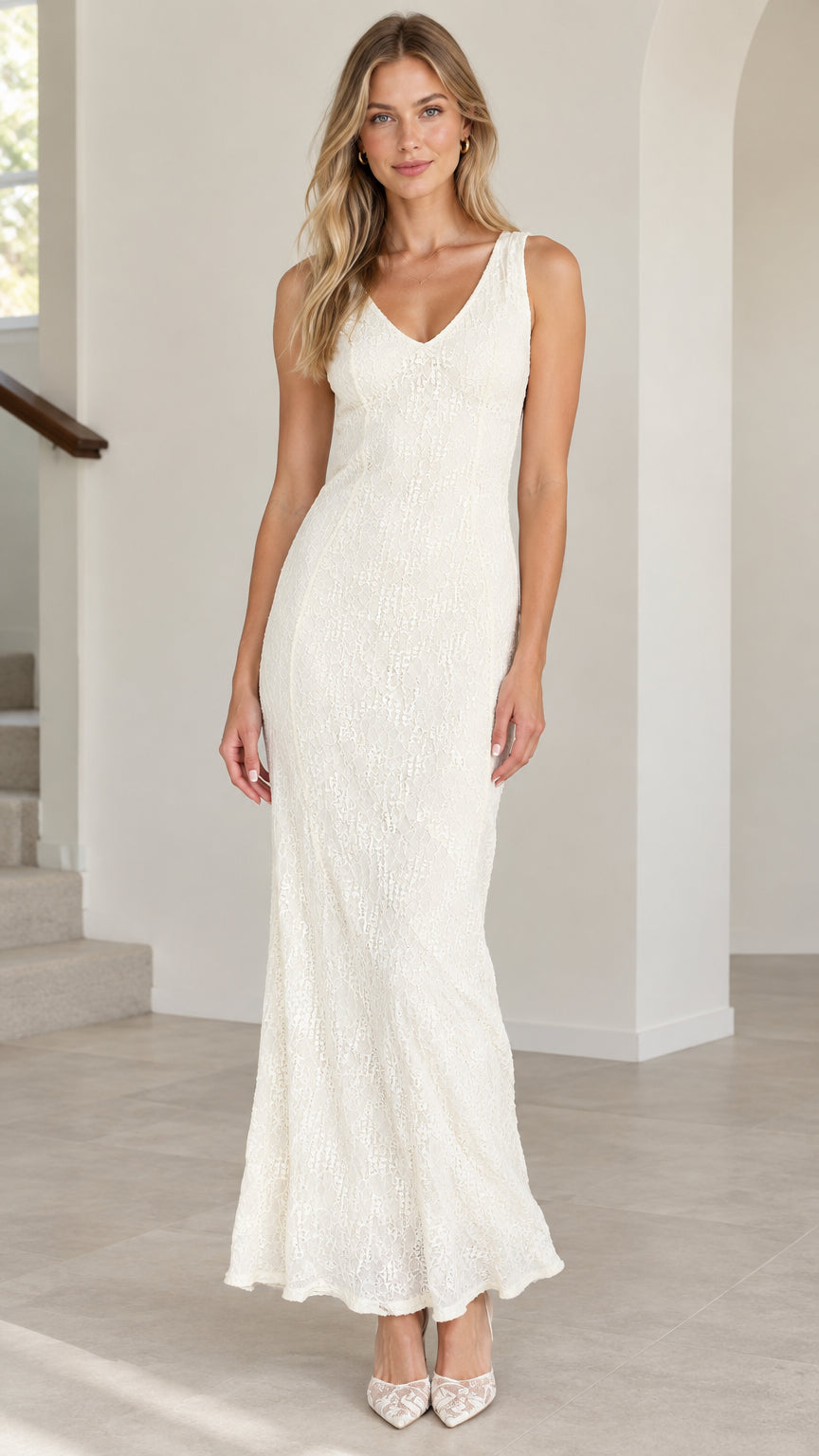 Front view of model wearing ivory sleeveless lace maxi dress with V-neckline