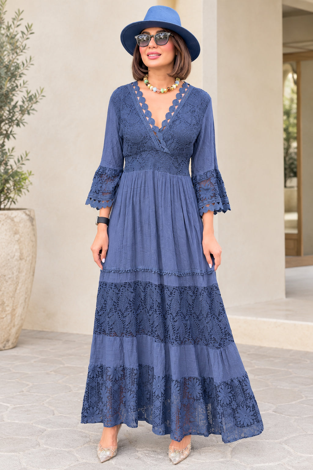 Front view of model wearing Slate Blue scalloped lace tiered maxi dress with hat