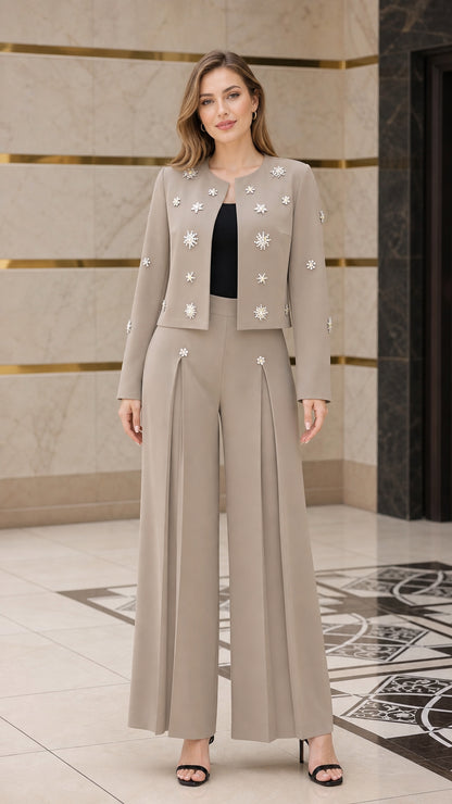 Front view of model wearing taupe embellished cropped jacket and wide-leg pant suit set
