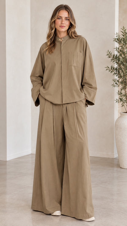 Front full-length view of woman wearing khaki two-piece shirt and wide-leg pants set