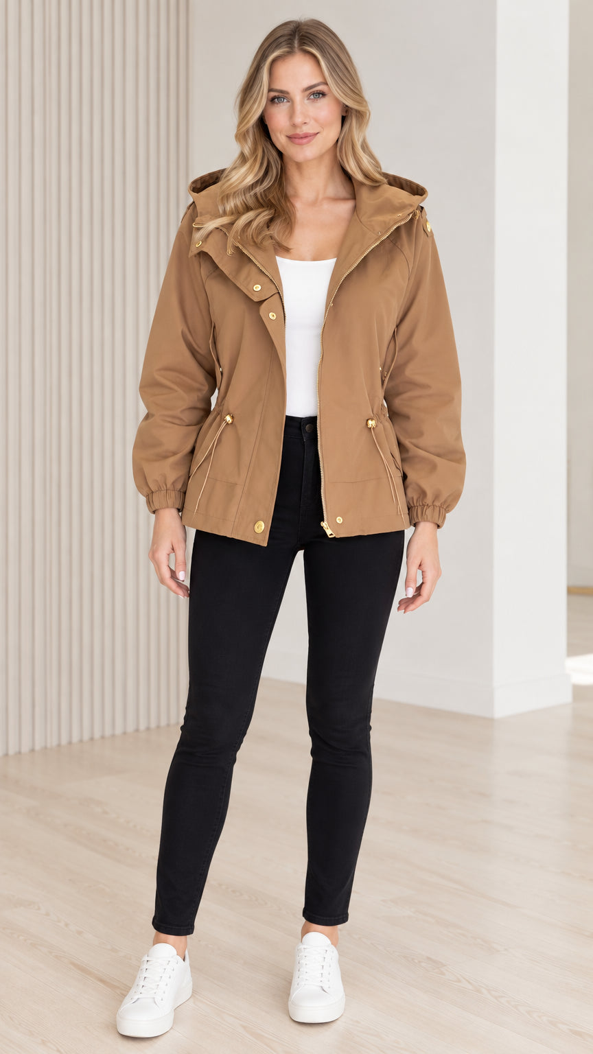 Front view of model wearing camel hooded drawstring utility jacket with black pants