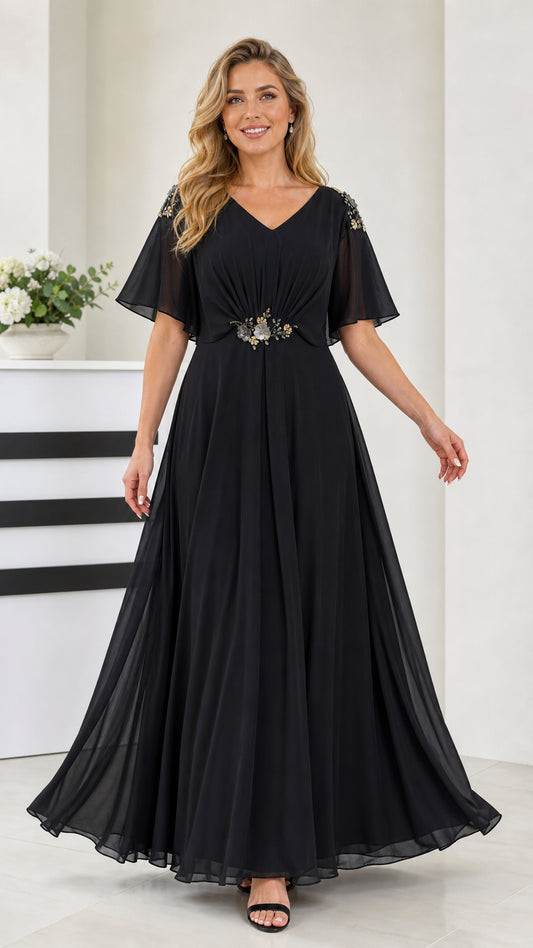 Front view of black flutter sleeve chiffon maxi evening dress with beaded waist detail