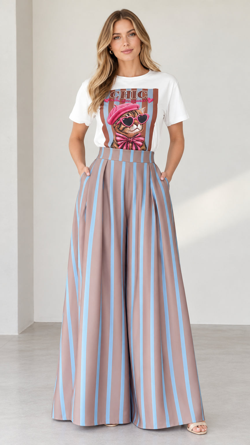 Front view of woman wearing white graphic tee and mocha blue striped wide-leg pants set