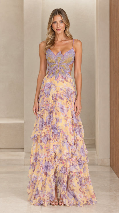 Front view of woman wearing pastel yellow floral chiffon maxi dress with beaded butterfly bodice