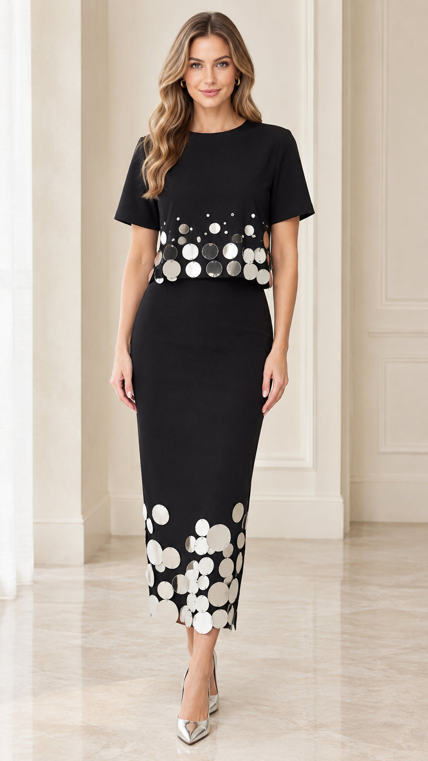 Front view of black short-sleeve midi dress with metallic disc embellishments