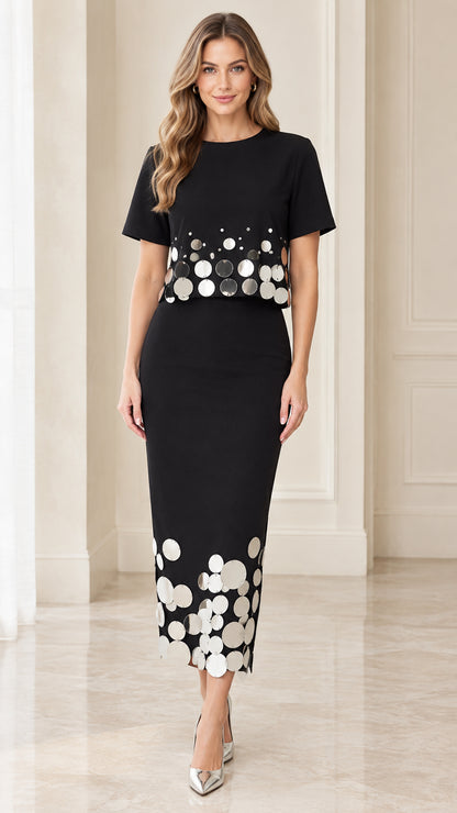 Front view of black short-sleeve midi dress with metallic disc embellishments