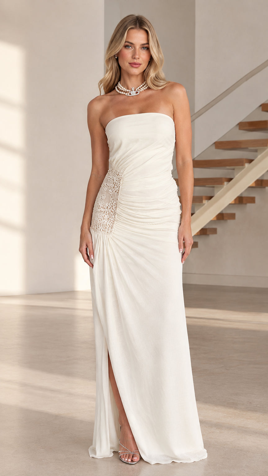 Model wearing white strapless ruched maxi dress with lace side panel and slit - front view