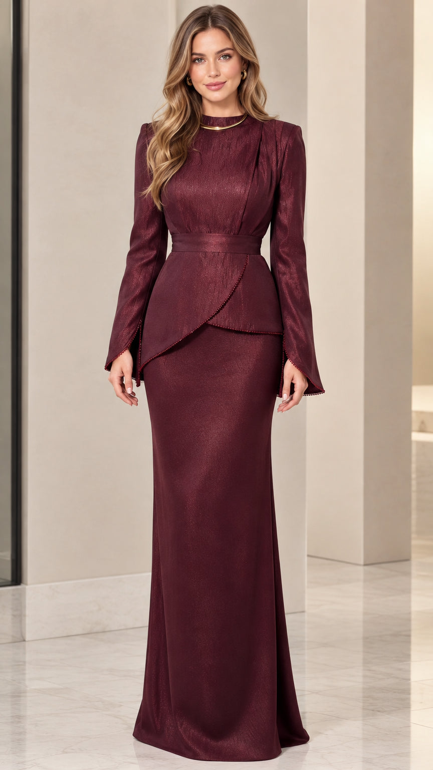 Front view of model wearing burgundy long sleeve asymmetrical peplum evening maxi gown