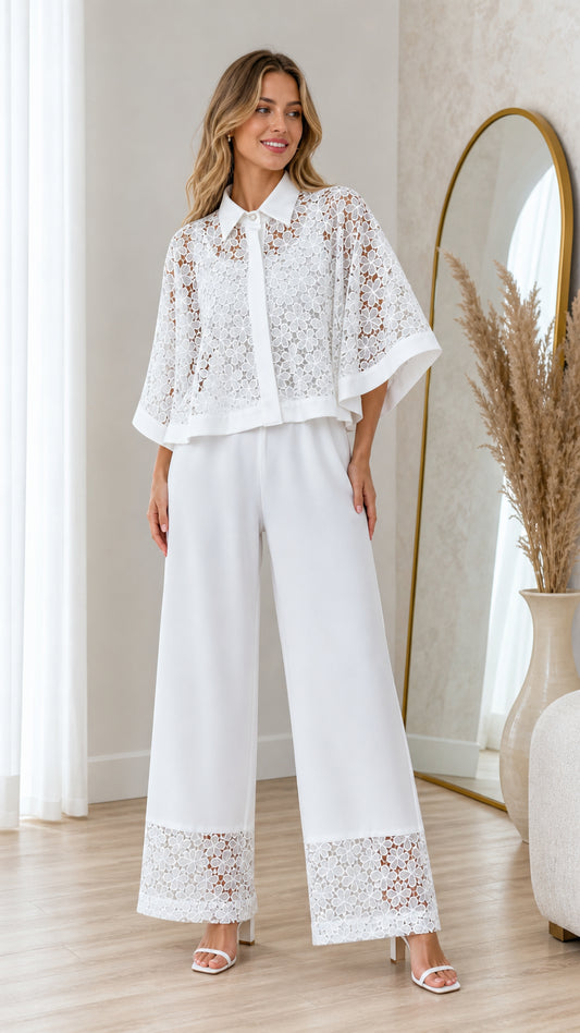 Front view of model wearing white floral lace cape top and matching wide leg pants