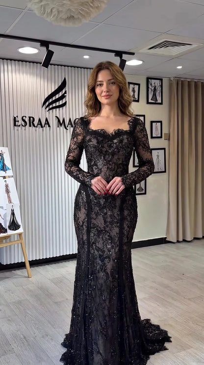 Full-length front view of black long sleeve lace mermaid evening gown