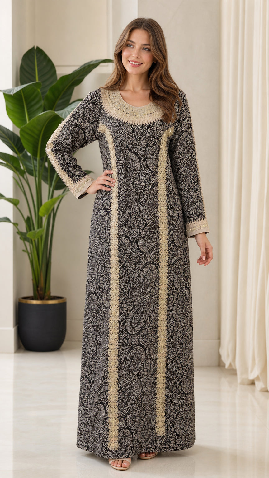 Full front view of model wearing black embroidered long sleeve kaftan maxi dress with gold trim