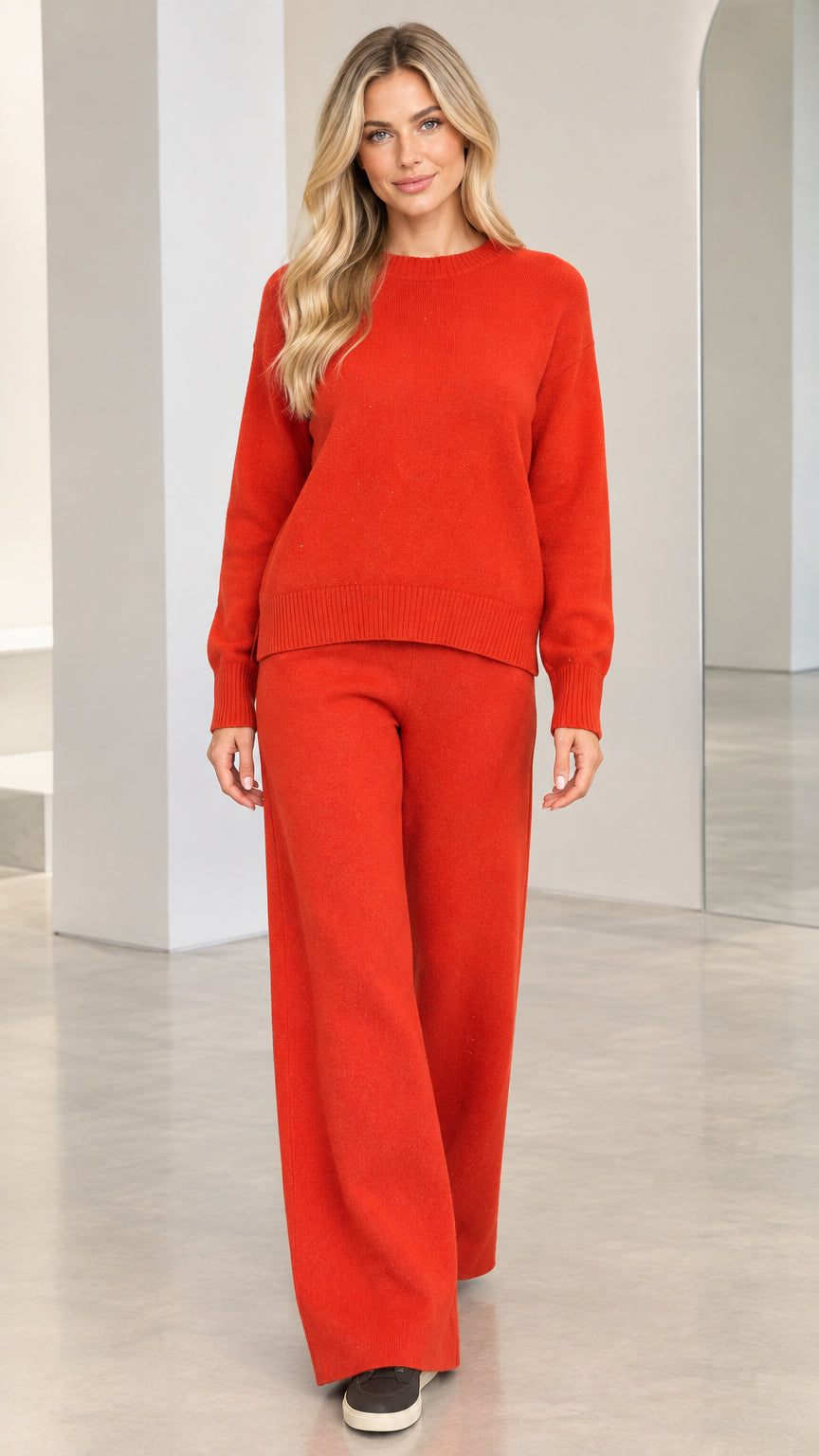 Front view of model wearing rust red knit sweater and matching wide-leg pants set