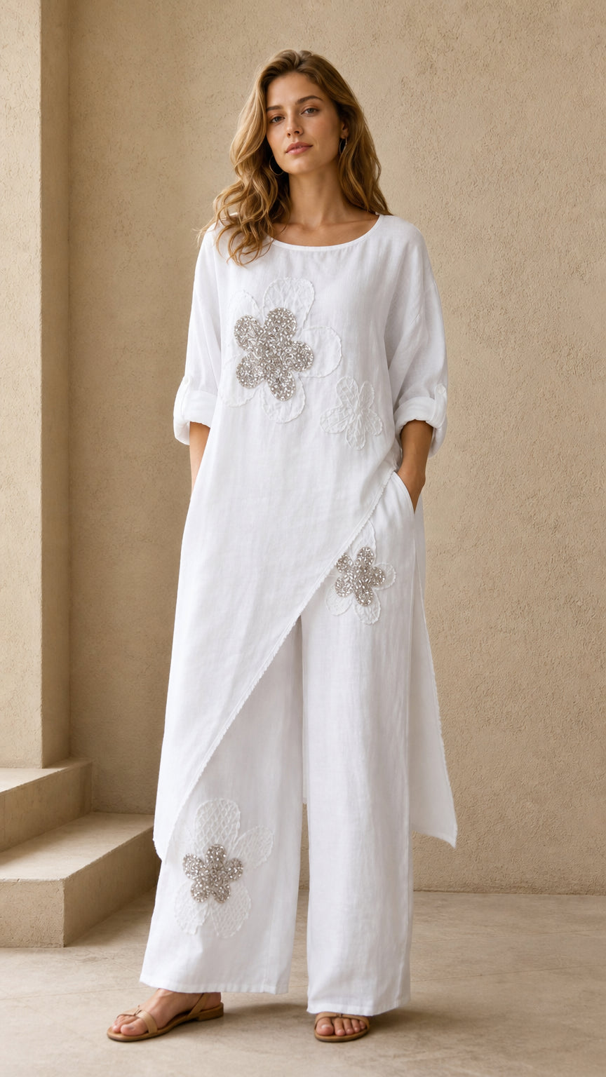 White asymmetric longline tunic and wide leg pants set with beaded floral detail - front view