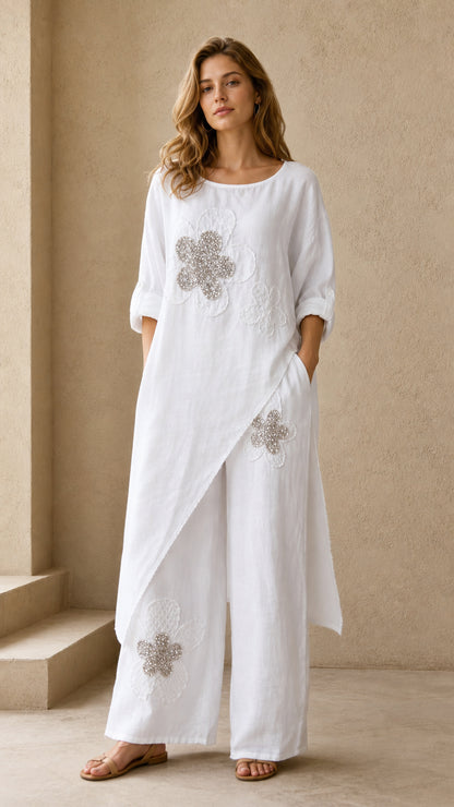 White asymmetric longline tunic and wide leg pants set with beaded floral detail - front view