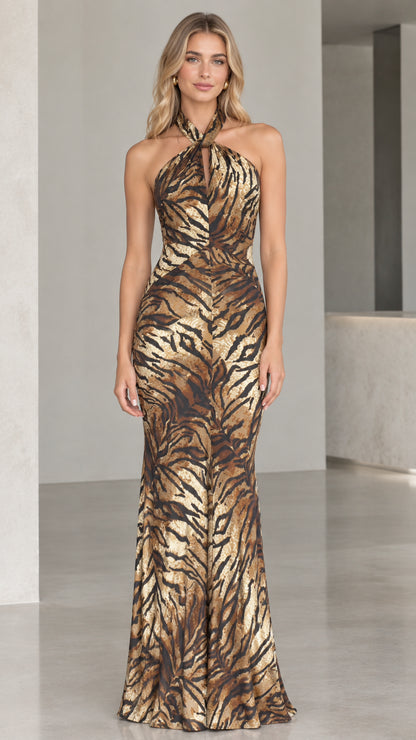 Front view of model wearing Bronze Gold halter neck shimmer animal print maxi gown