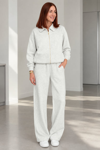 Front view of woman wearing Heather Grey collared zip-up lounge set with wide-leg pants