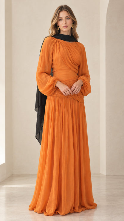 Full-length front view of woman wearing orange pleated chiffon maxi dress with black neck scarf