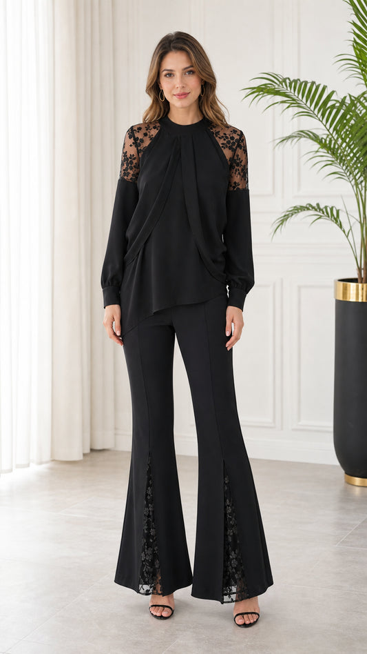 Front full-length view of model wearing black long sleeve lace patchwork top and matching flare pants set