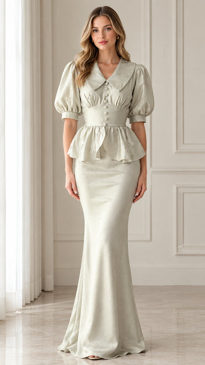 Front view of woman wearing sage green vintage peplum maxi dress with embroidered collar