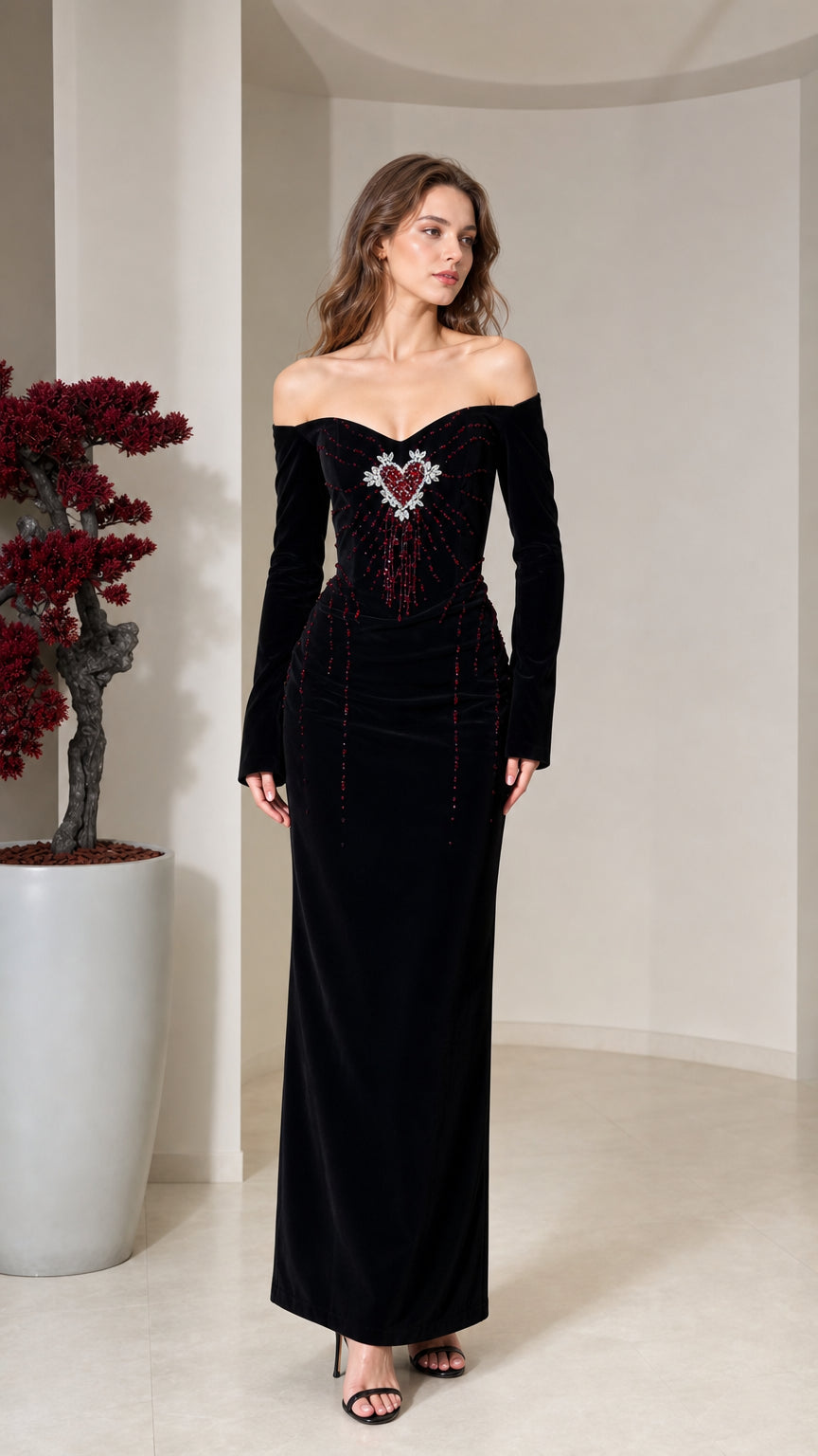 Front view of model wearing black off-the-shoulder velvet maxi dress with beaded heart bodice