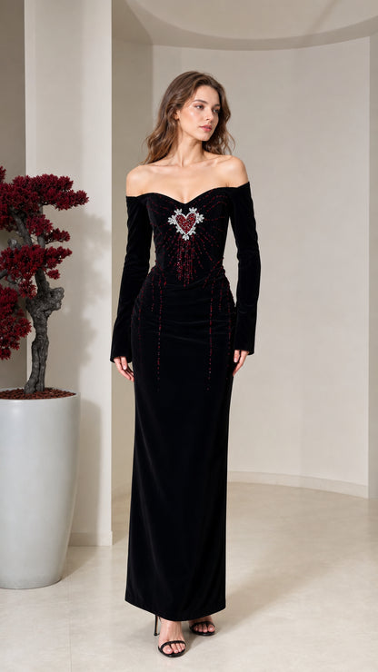 Front view of model wearing black off-the-shoulder velvet maxi dress with beaded heart bodice