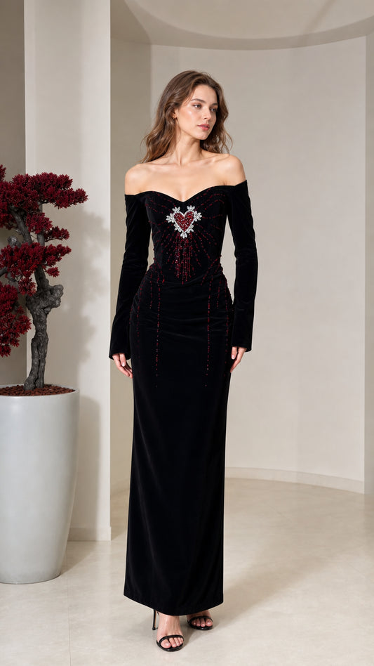 Front view of model wearing black off-the-shoulder velvet maxi dress with beaded heart bodice