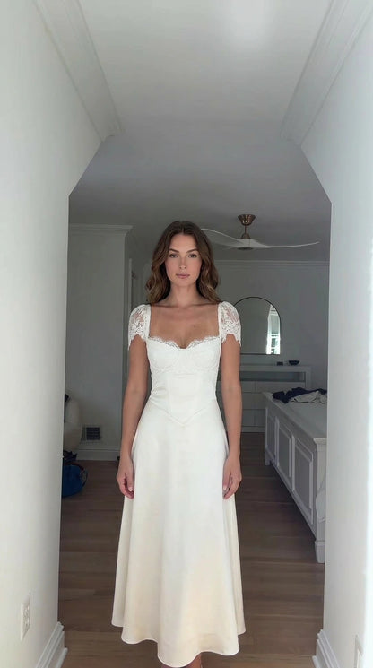 Front view of model wearing white lace cap-sleeve corset maxi dress