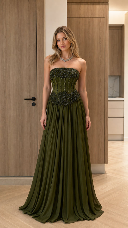 Front view of model wearing olive green strapless beaded corset pleated maxi gown