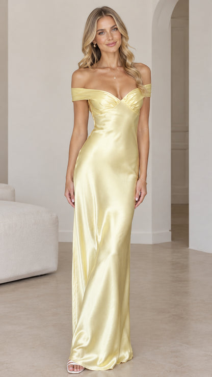 Front view of woman wearing butter yellow off-the-shoulder satin maxi dress