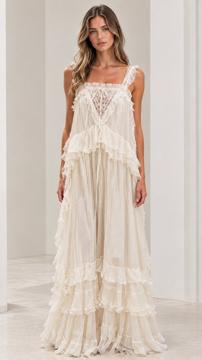 Front view of woman wearing ivory lace-trimmed tiered ruffled maxi dress
