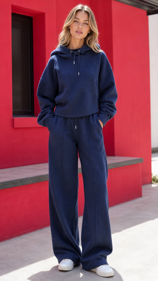 Front full-length view of woman wearing navy blue hoodie and wide-leg sweatpants set