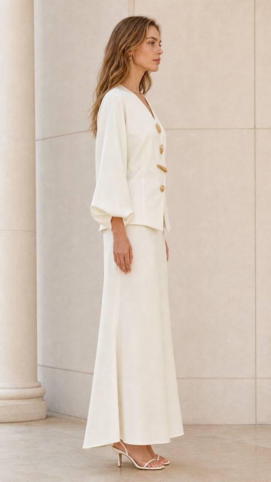 Side profile view of model wearing ivory tailored two-piece maxi skirt set