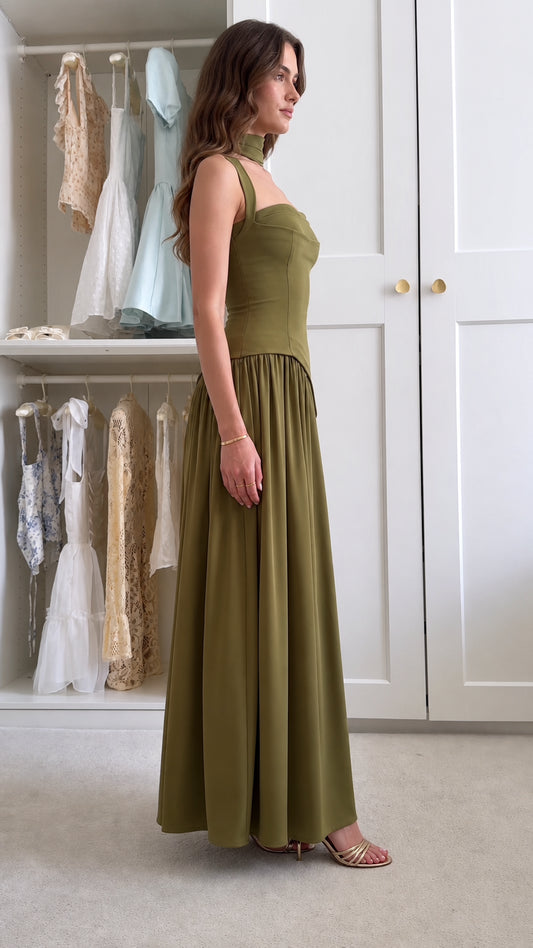 Side profile view of olive green drop waist pleated evening gown