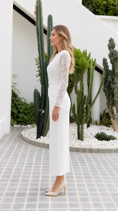 Side profile of model wearing white lace long sleeve column dress